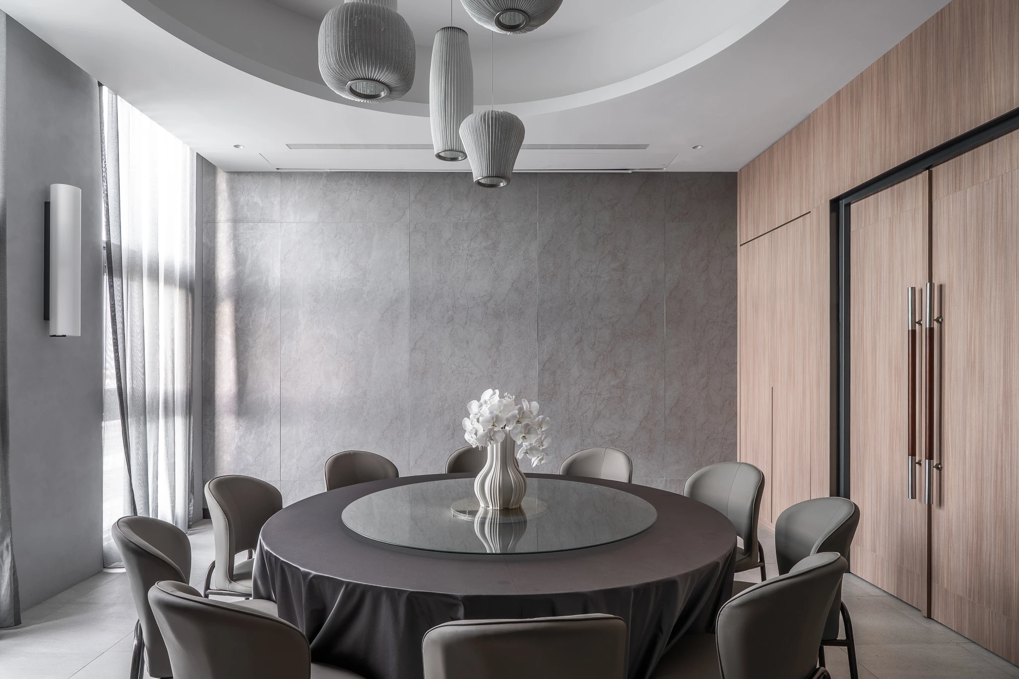 Round dining table in a grey and timber room