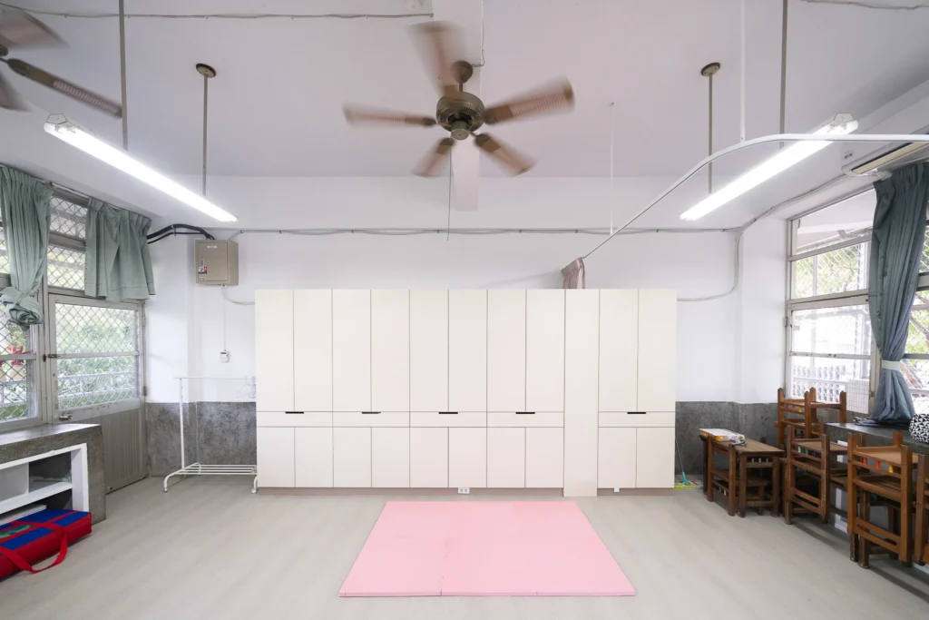Renovated classroom with pale storage cabinets and an open floor area