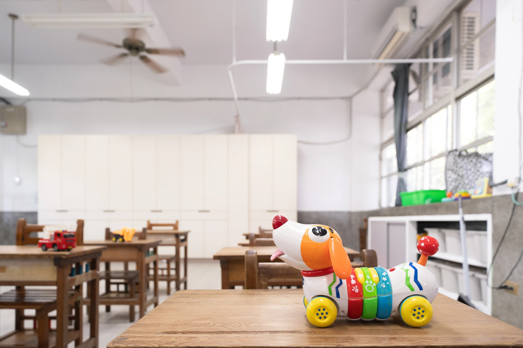 Learning toys on desks facing the storage wall