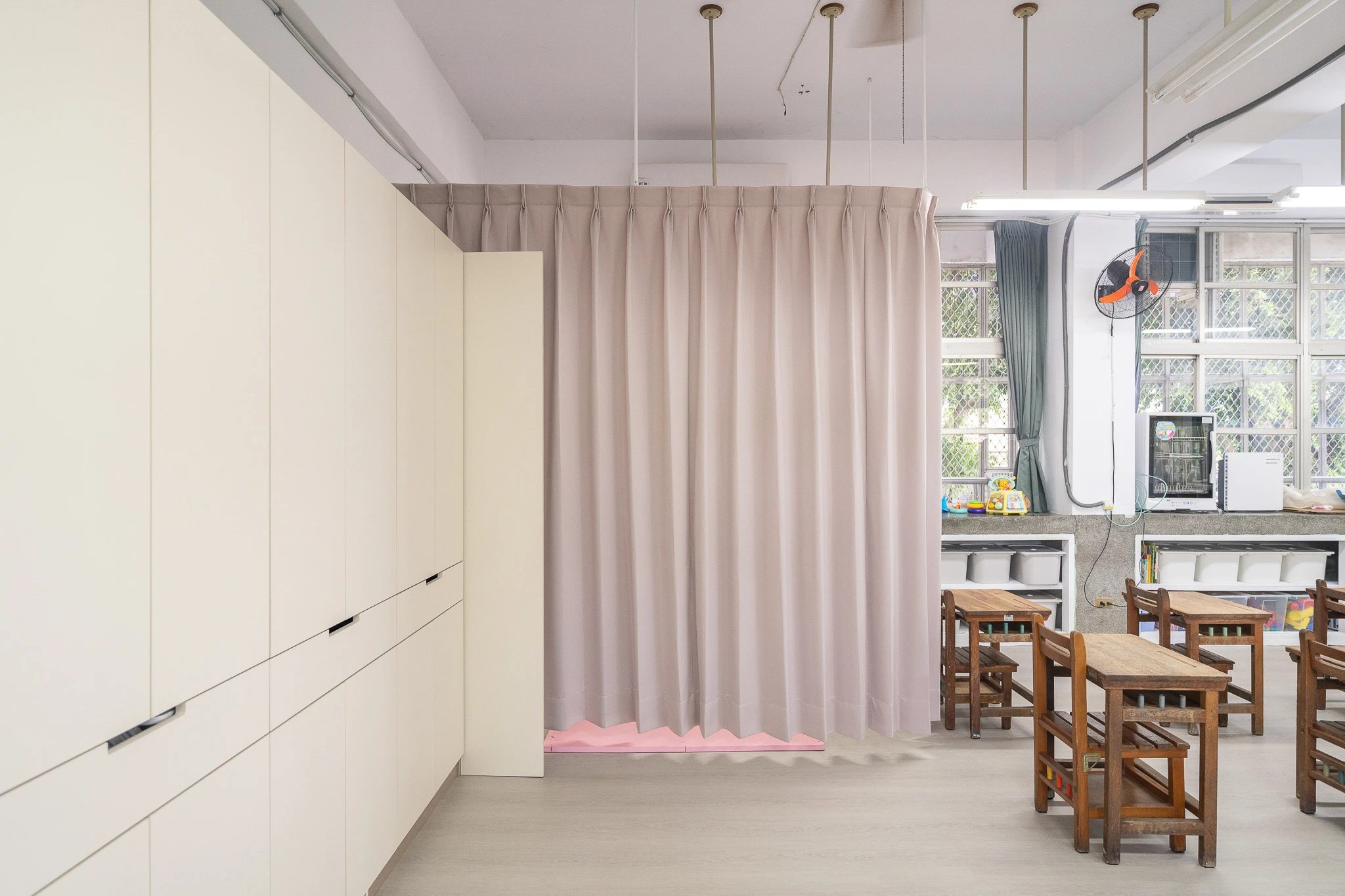 Full-height cabinets beside a curtain partition