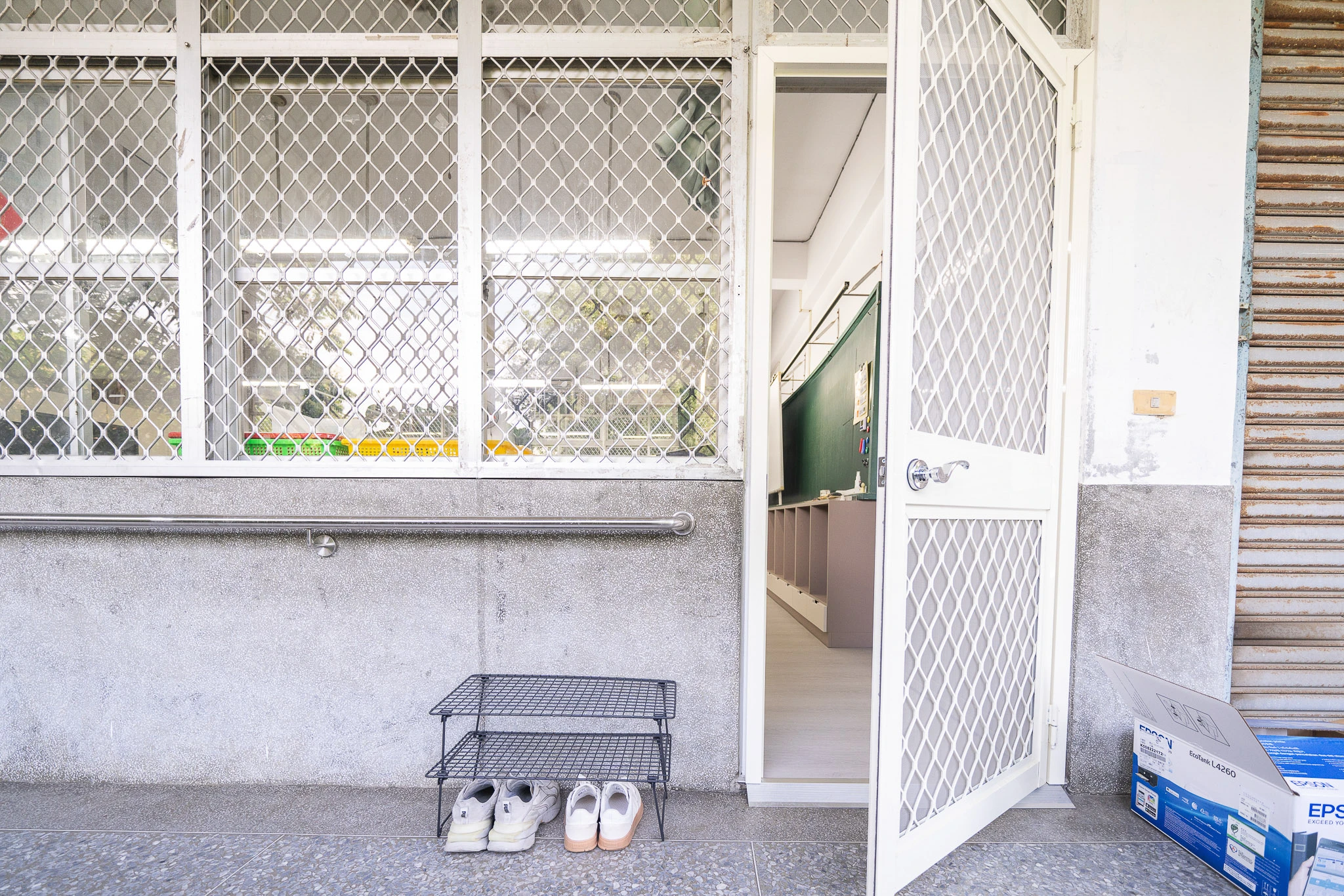 Classroom doorway with a low shoe rack outside