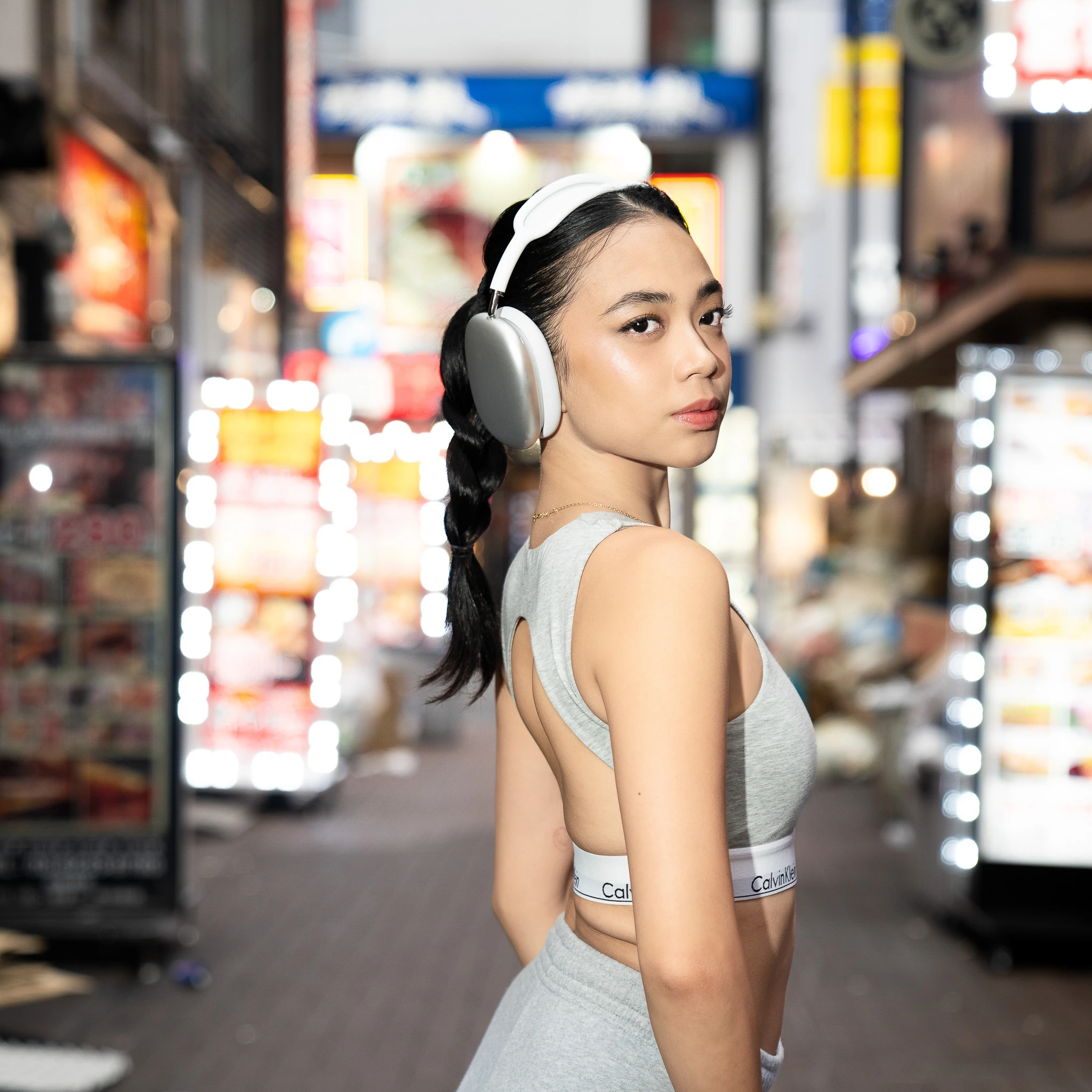 Over-the-shoulder portrait among Shinjuku street lights