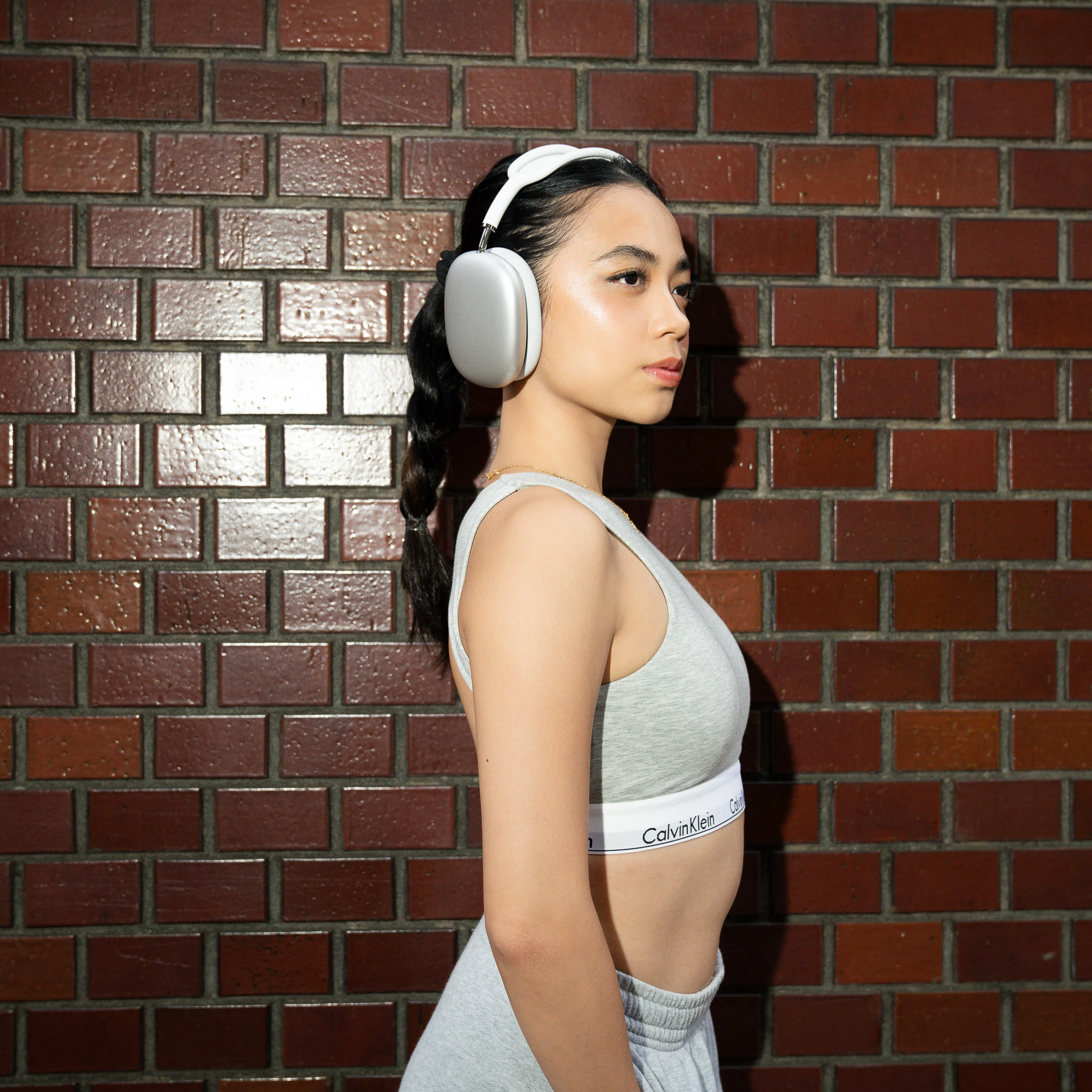 Side view of headphones against the brick-wall backdrop