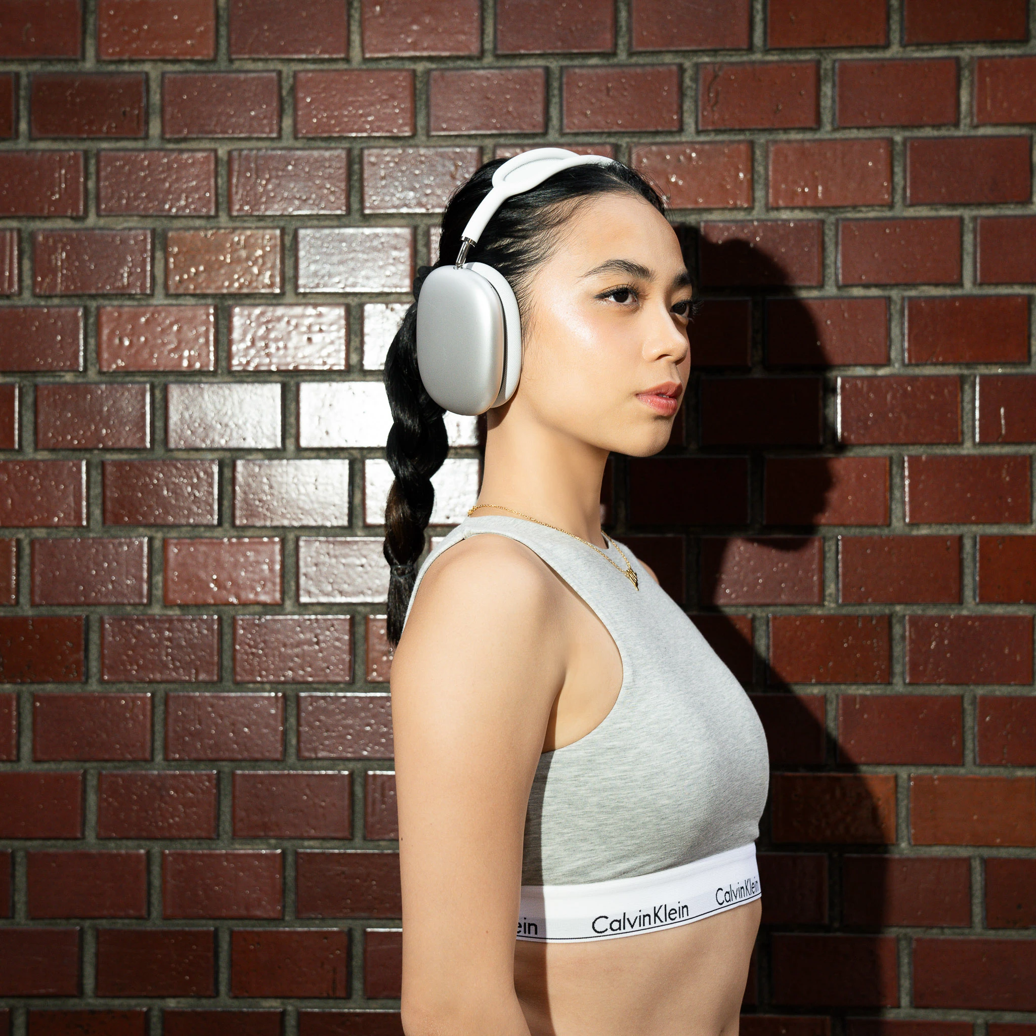 Close side portrait showing headphones and outfit details