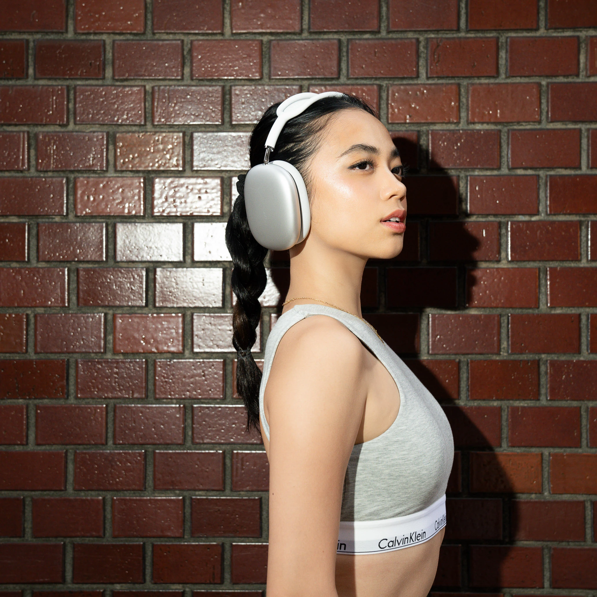 Side profile with silver headphones and grey Calvin Klein styling