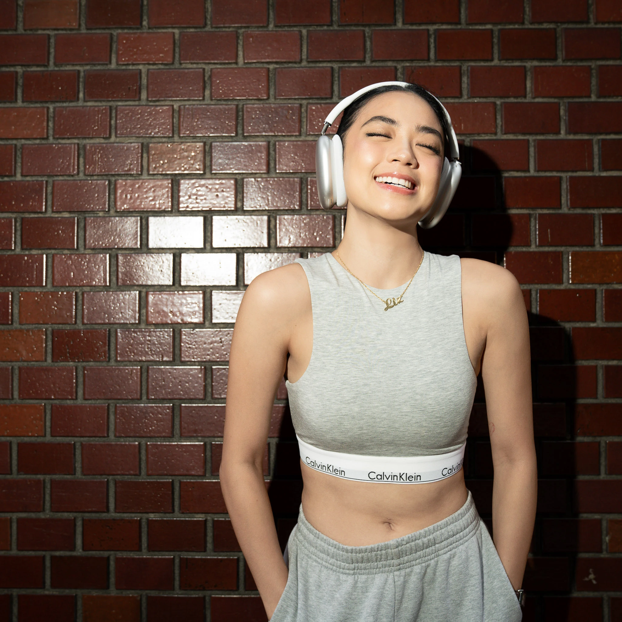 Relaxed smiling portrait with grey styling and headphones