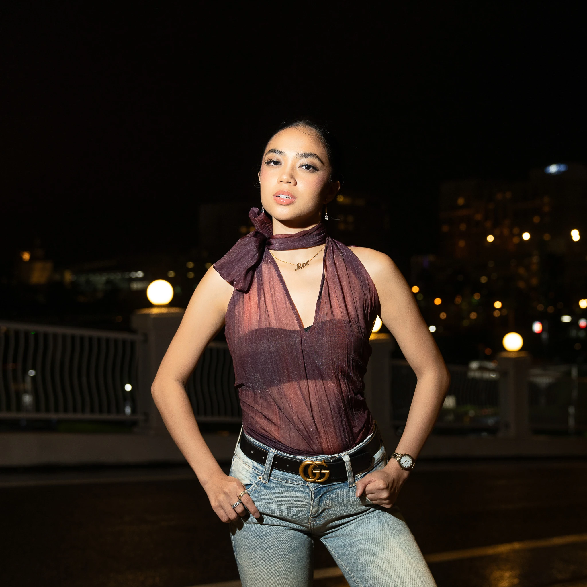 Portrait with burgundy fabric against a dark outdoor setting