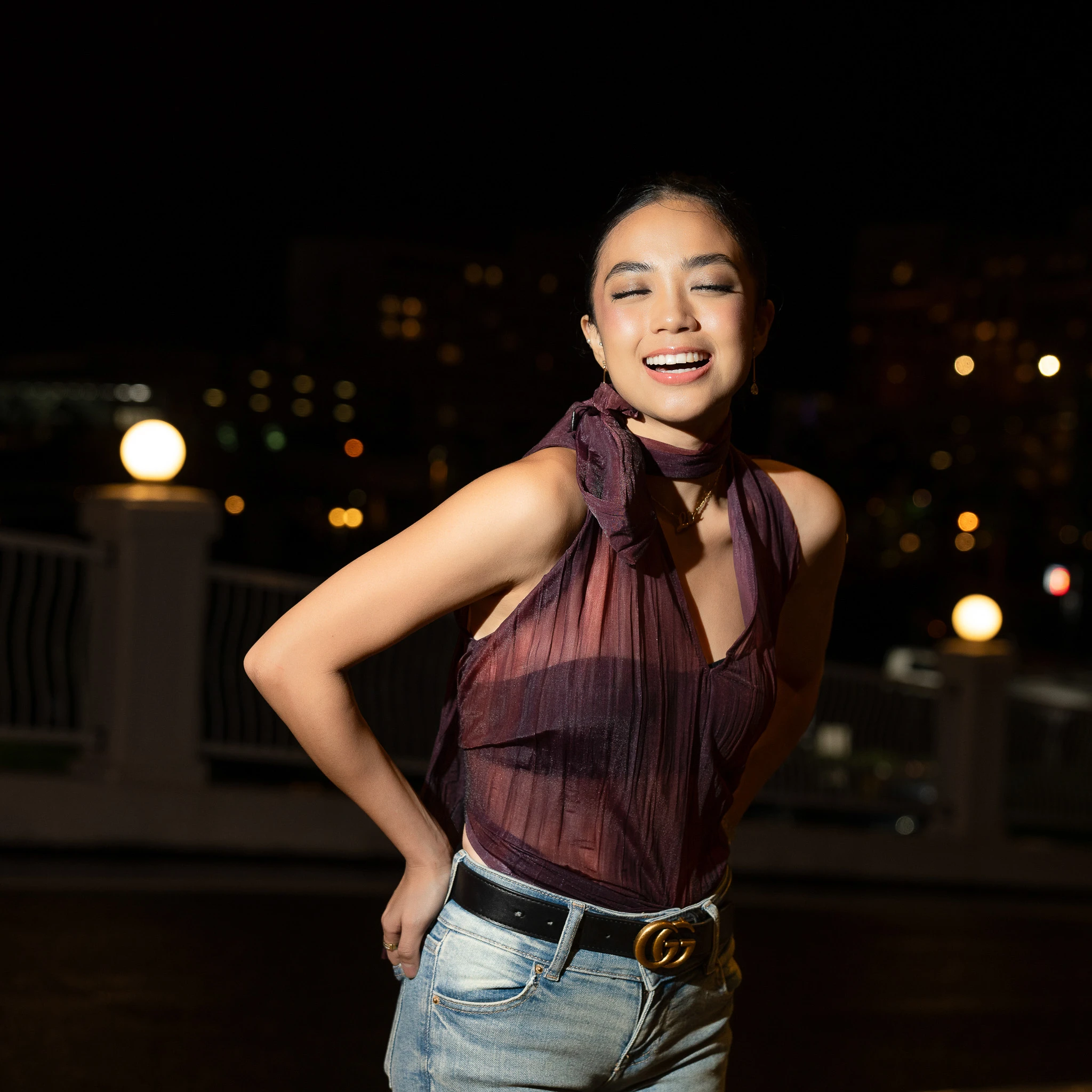 Smiling night portrait with burgundy styling and hoop earrings