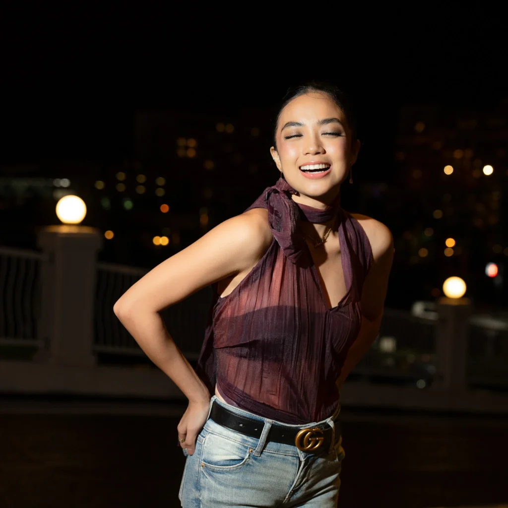 Smiling night portrait with burgundy styling and hoop earrings