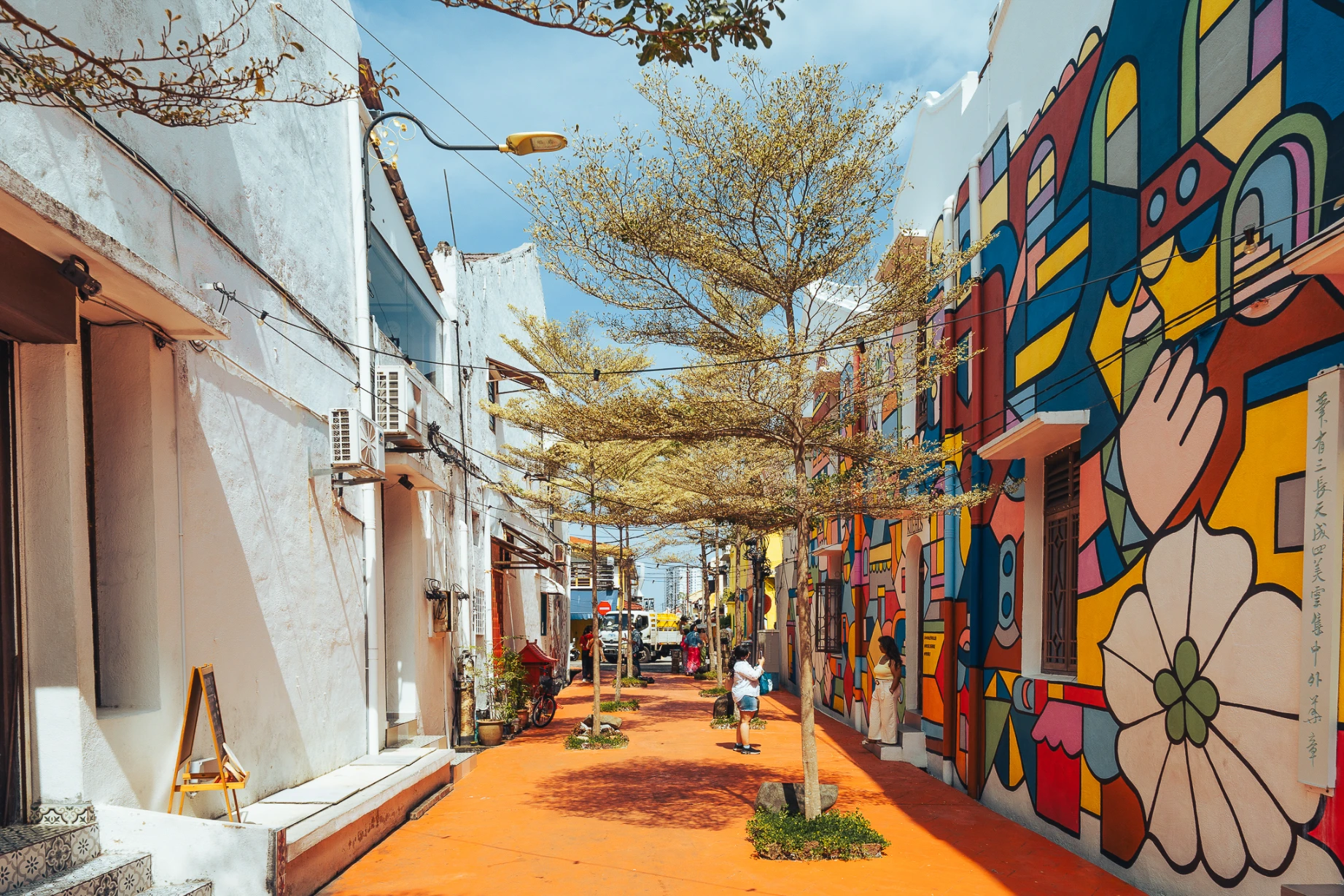 Red colonial architecture and public activity at Dutch Square in Melaka.