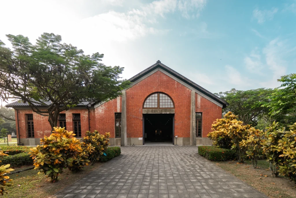 A red brick heritage building with a tall arched entrance.