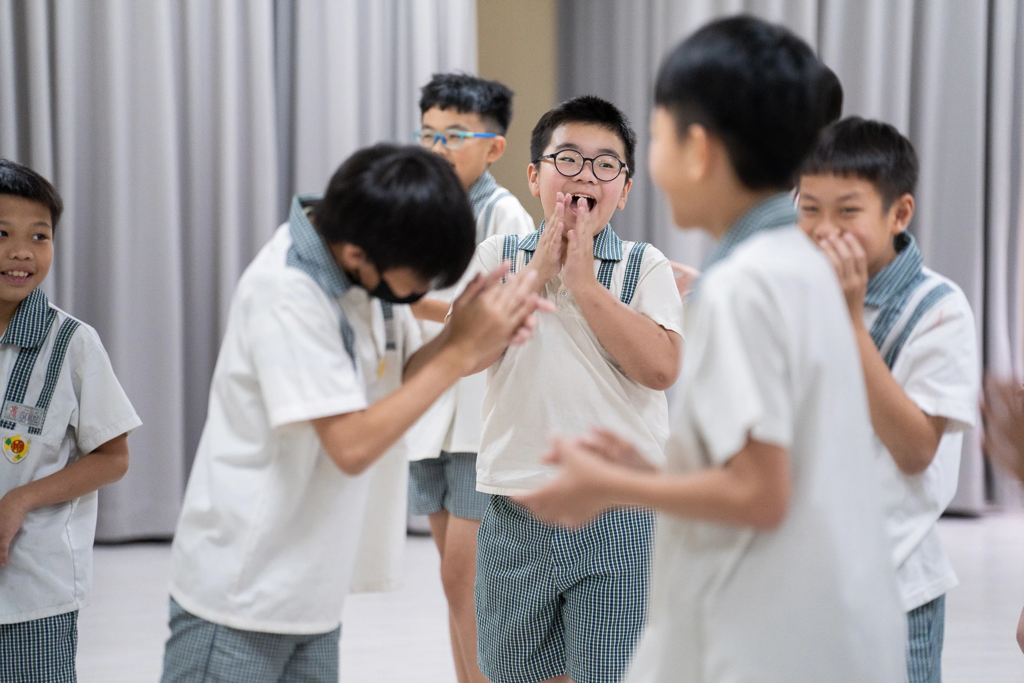 Students laughing together during a classroom workshop.
