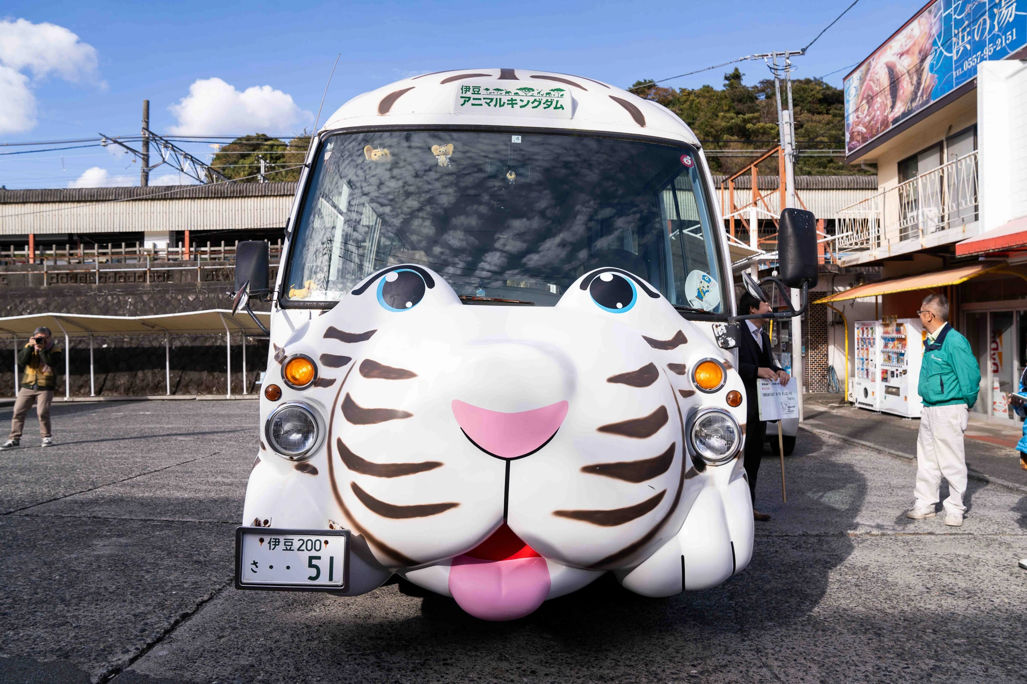 Animal-themed visitor bus parked beside a building