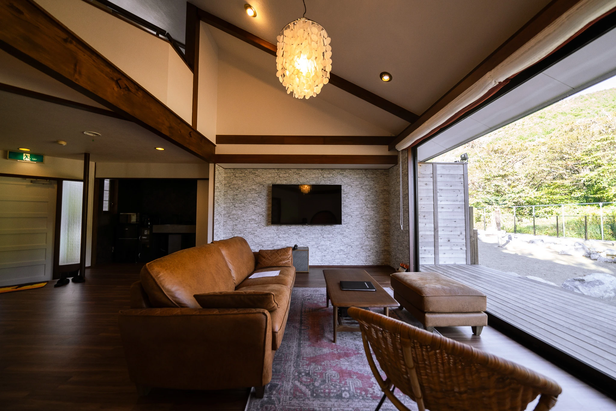 Living area with timber beams and an outdoor view