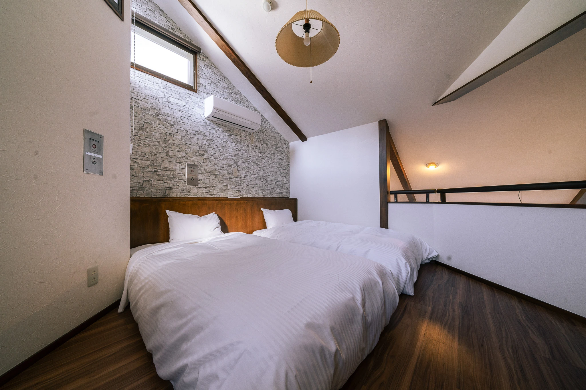 Guest bedroom beneath a sloping ceiling