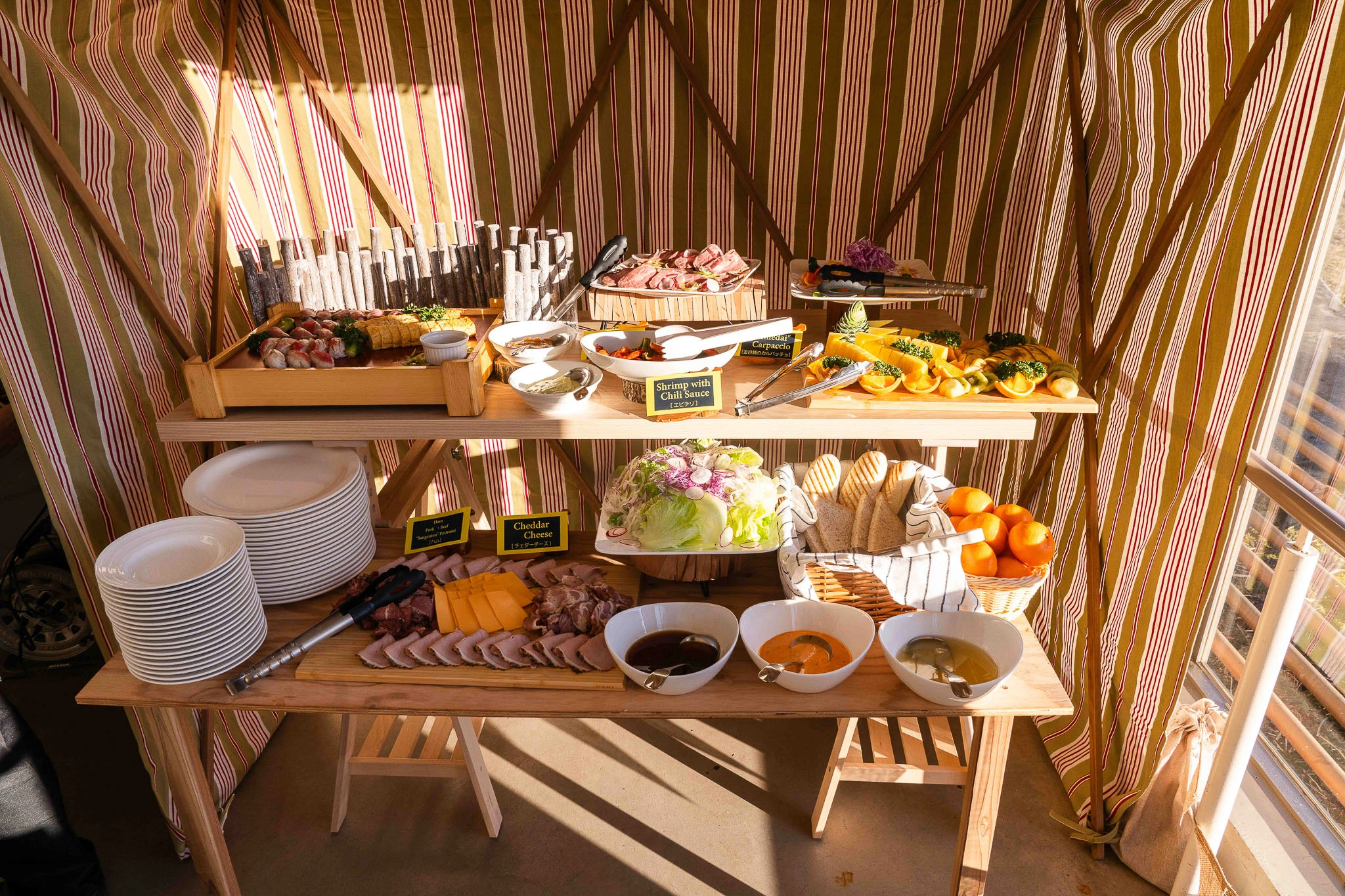 Breakfast buffet arranged on wooden shelves
