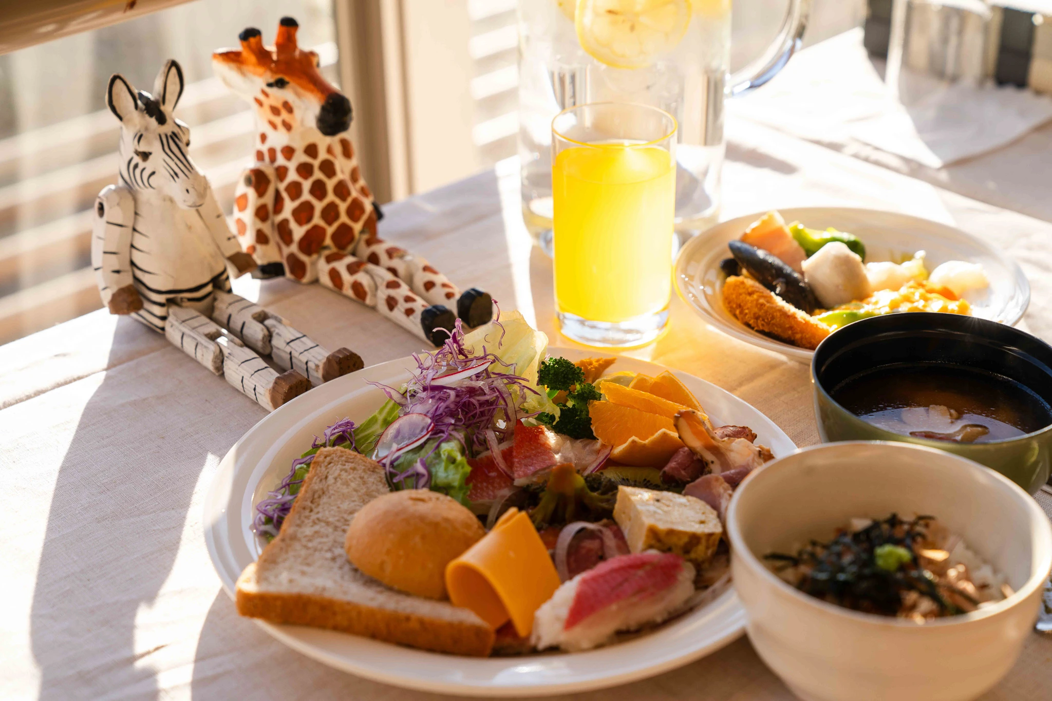 Breakfast plate with fruit, salad and a glass of juice