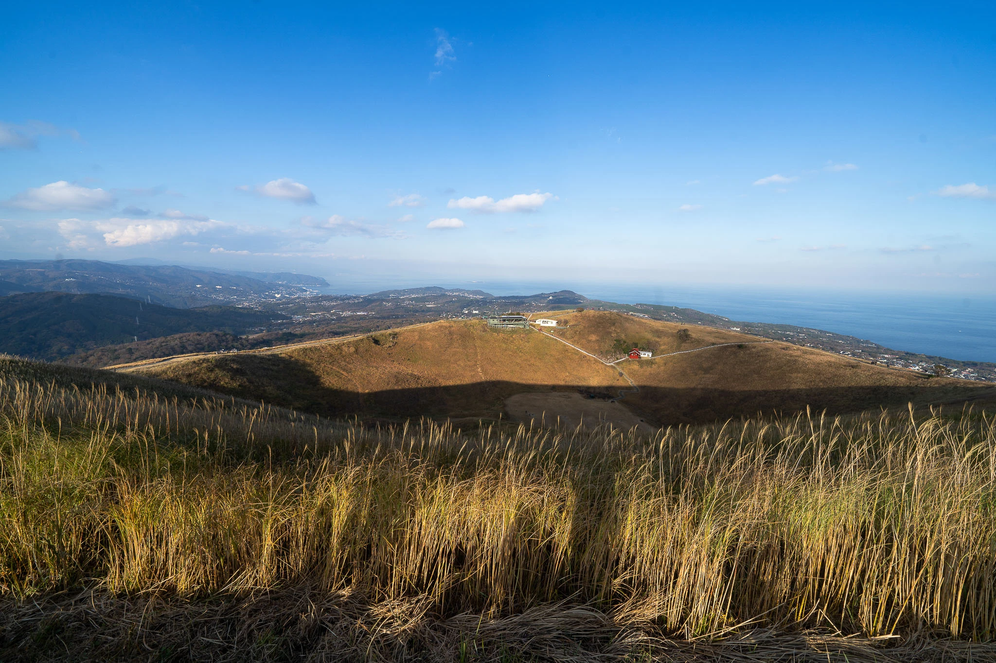 Open grassy hills beneath a blue sky