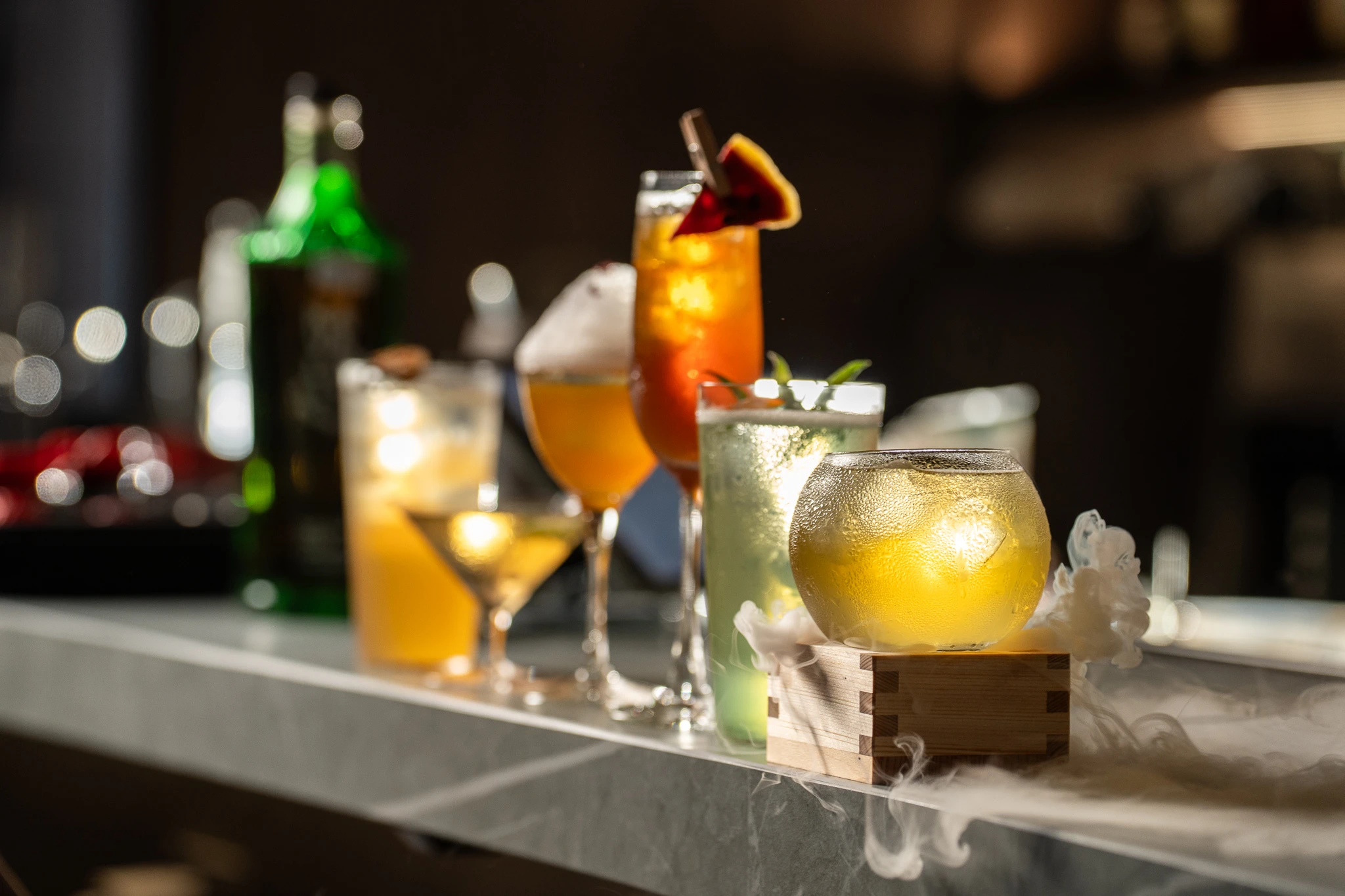 Signature cocktails from Moonwell's 2026 menu photographed inside the bar.
