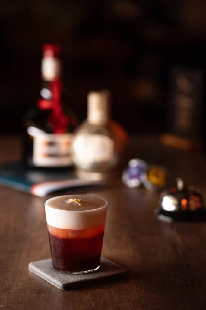 Layered cocktail on a bar counter at Moonwell