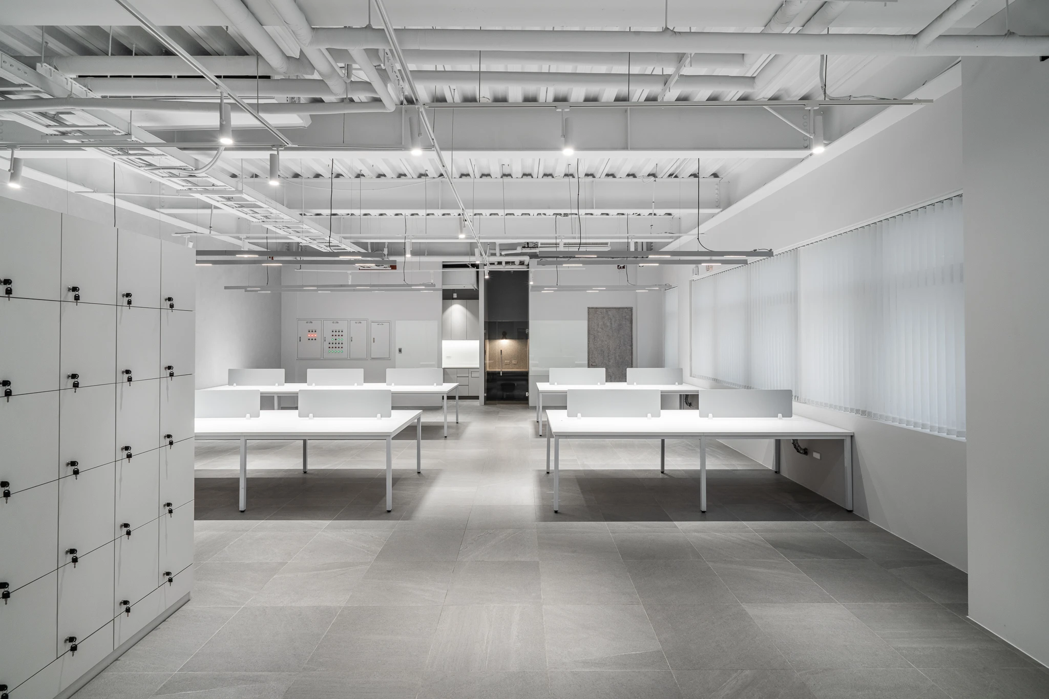 Office aisle between lockers and workstations