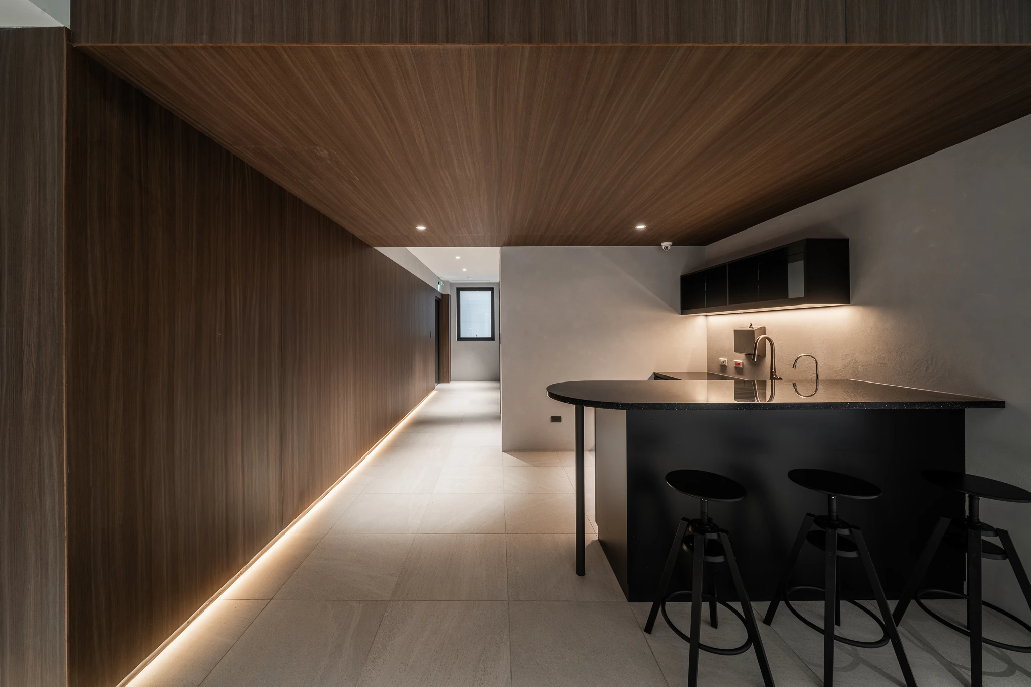Long timber-lined bar area with a curved counter