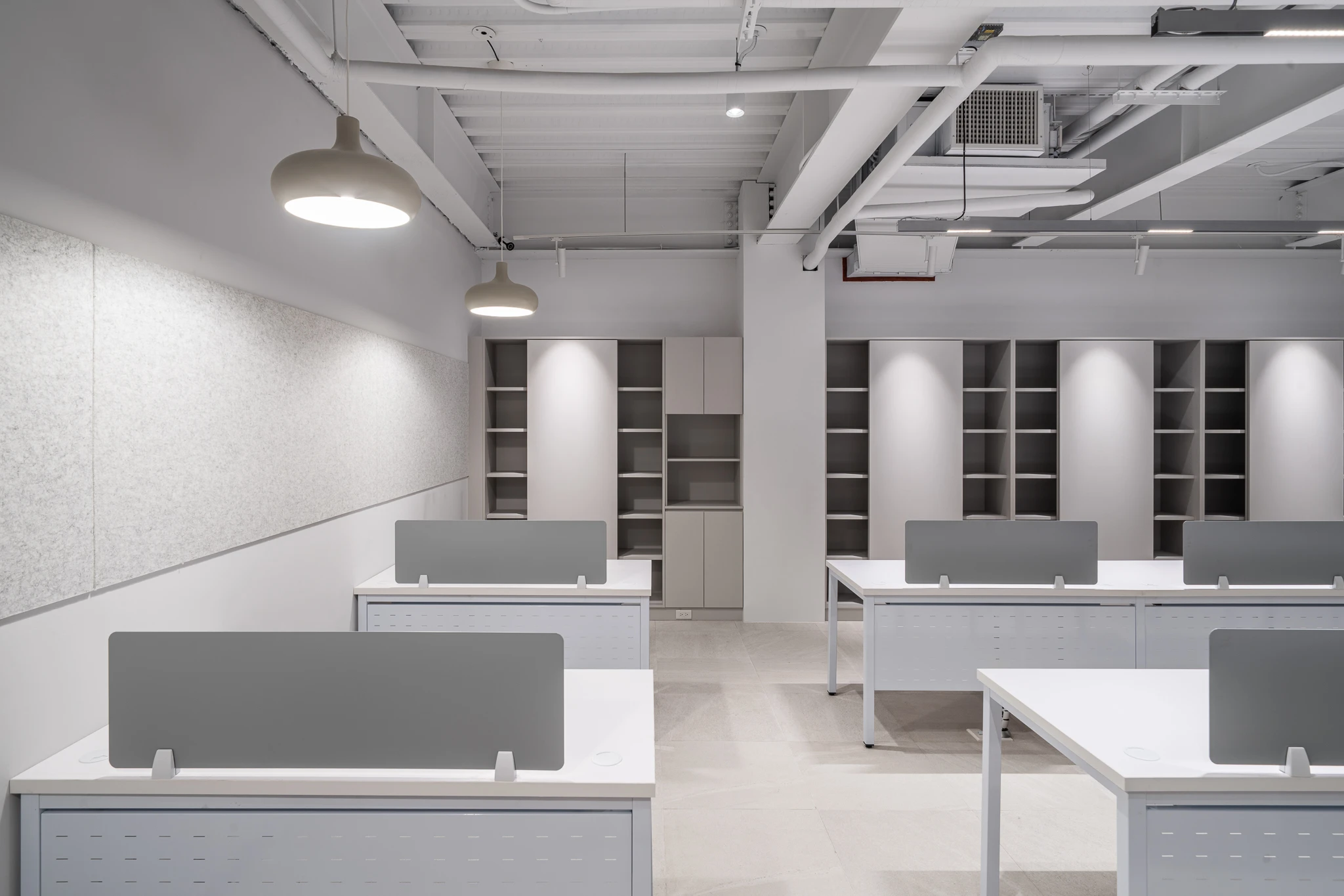 Low desk partitions with pendant lights above