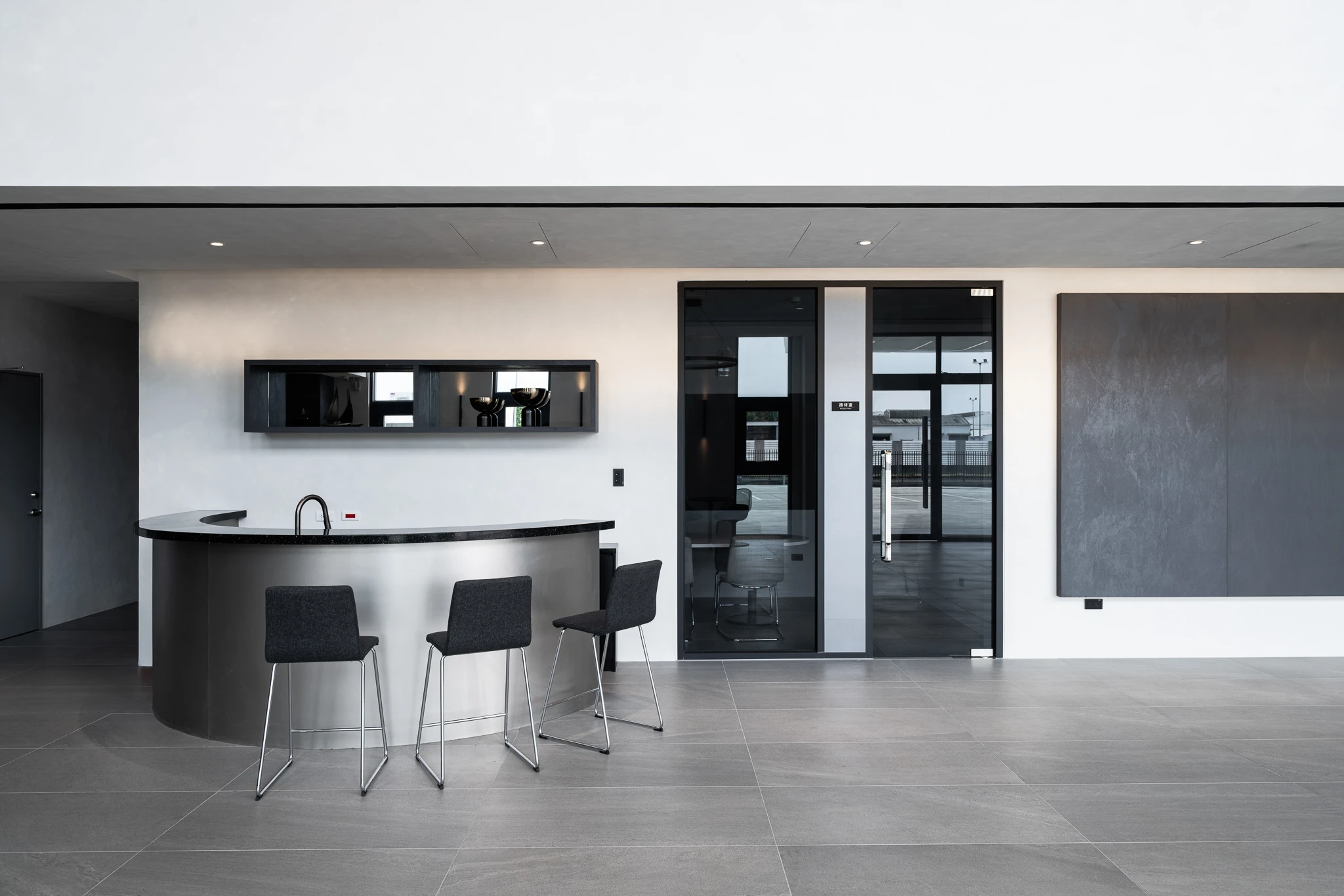 Curved counter with three chairs in the reception area