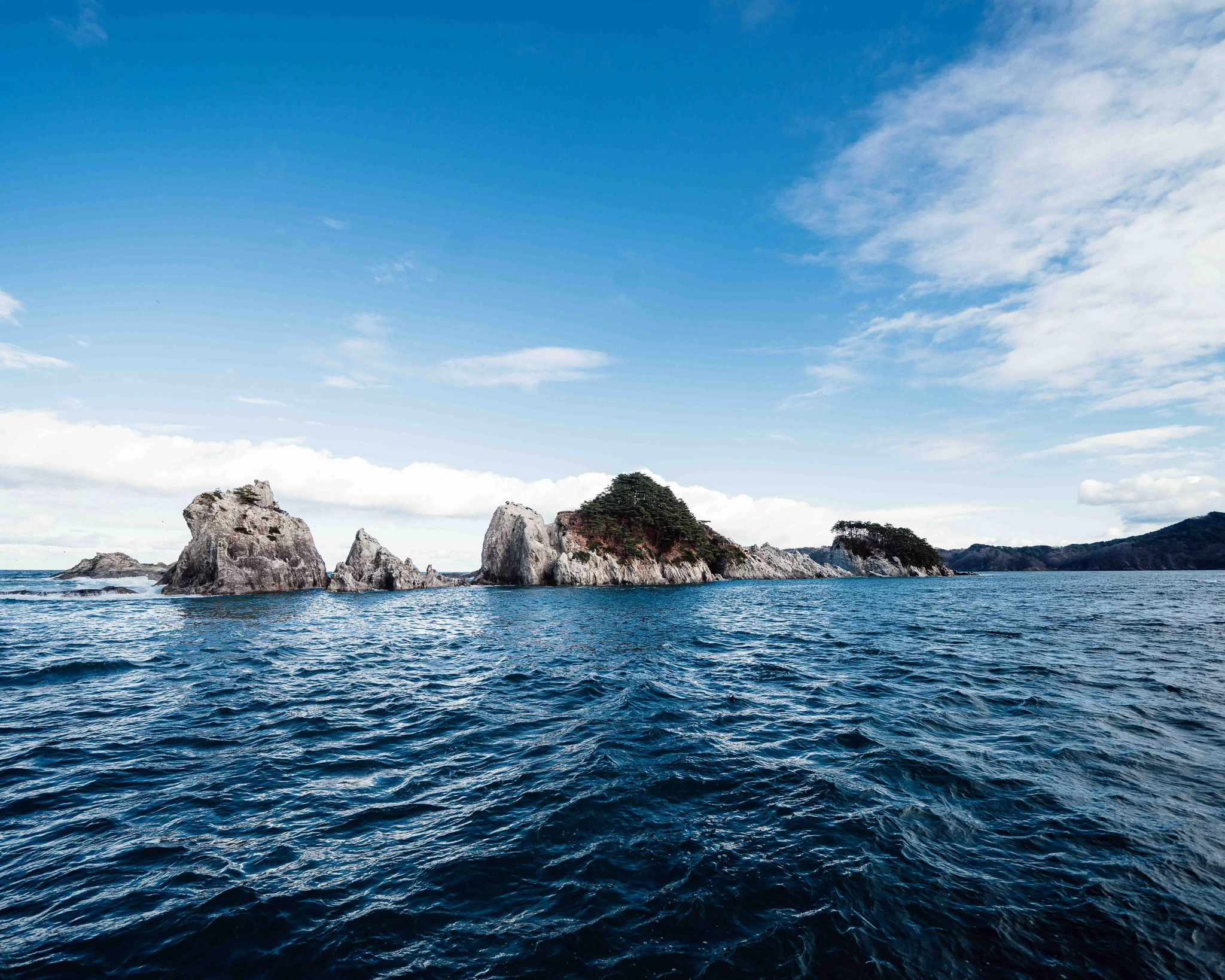 White rocks seen across the blue water at Jodogahama