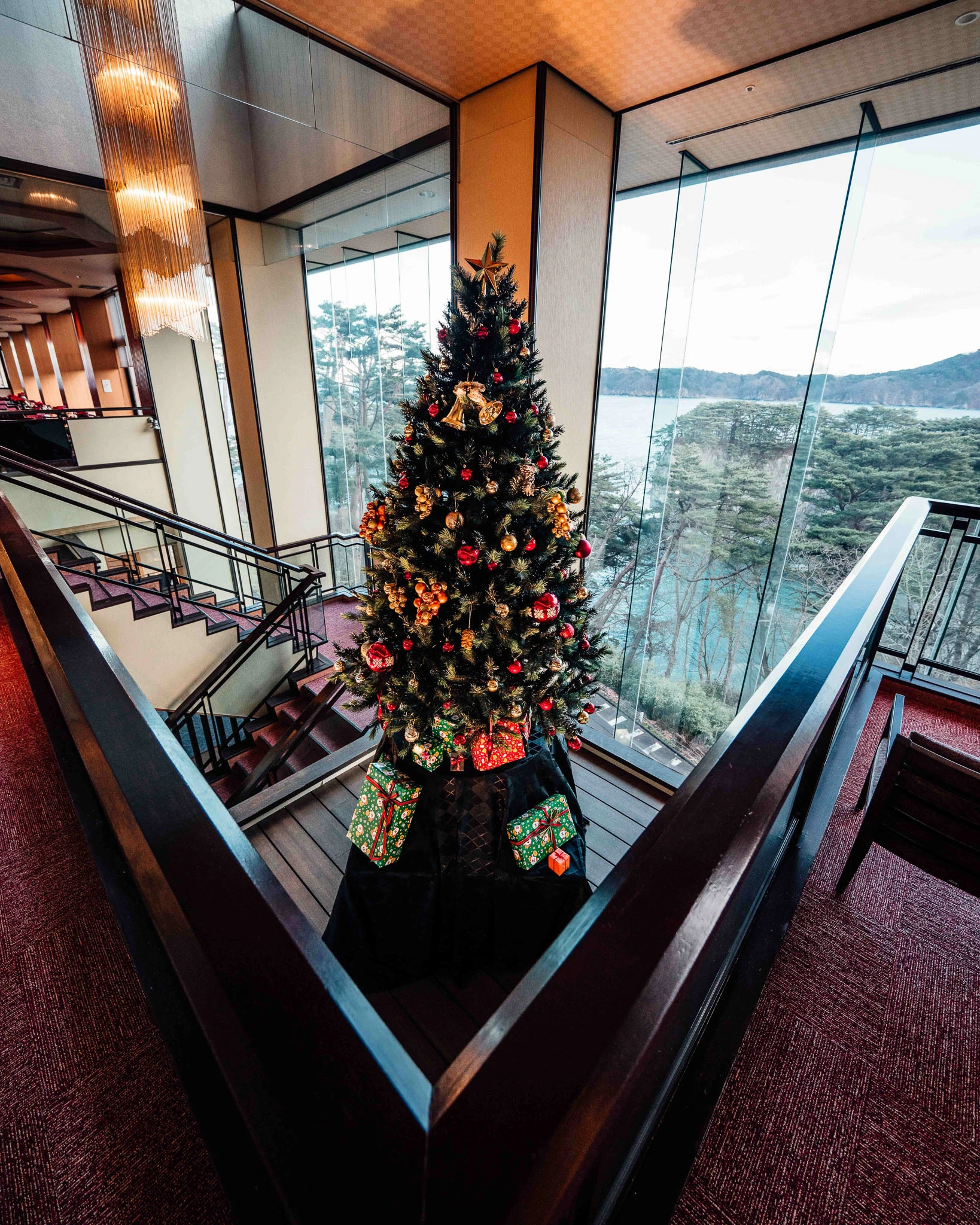 Christmas tree beside a tall lounge window
