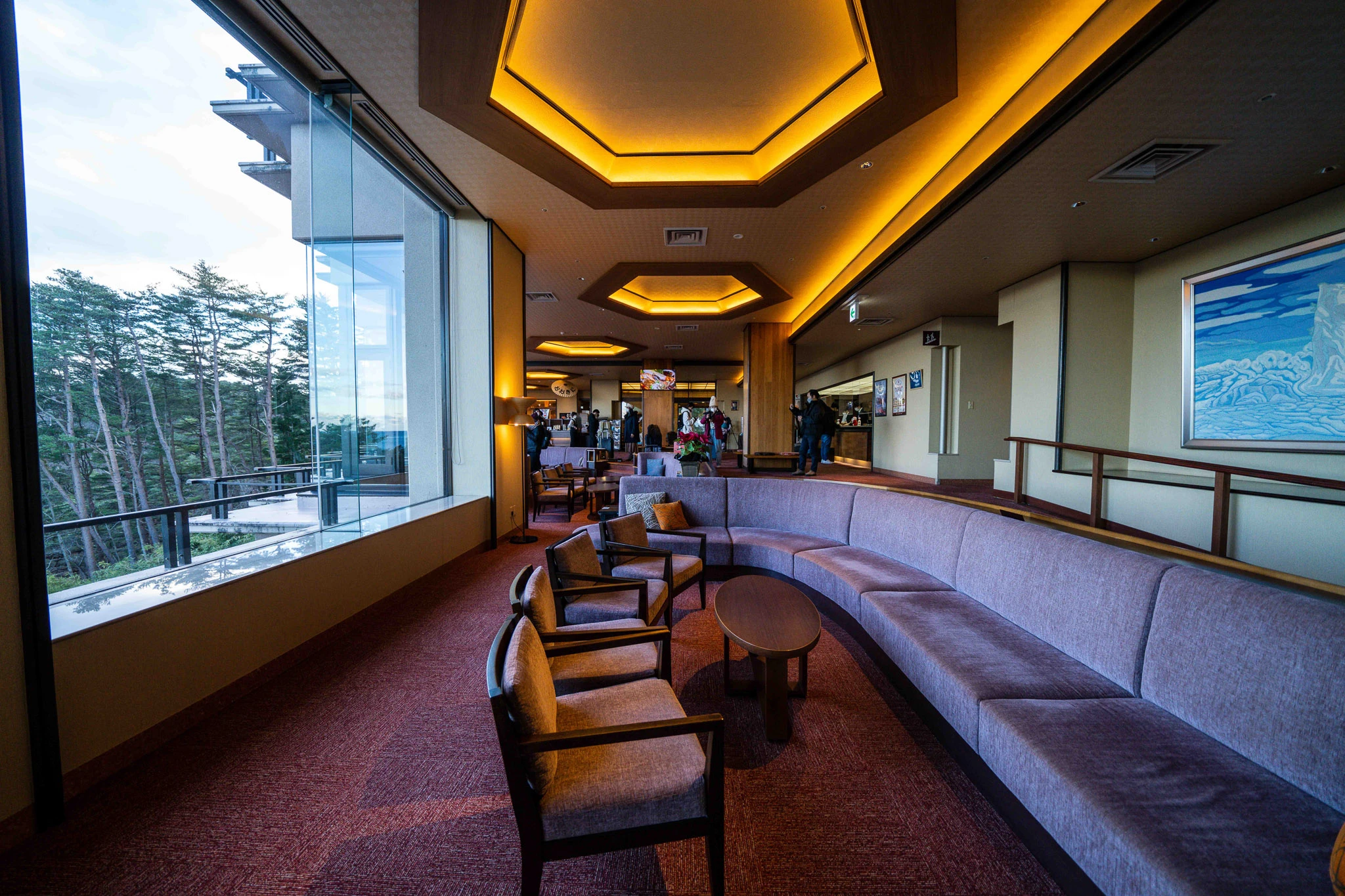 Hotel lounge with armchairs facing a long window
