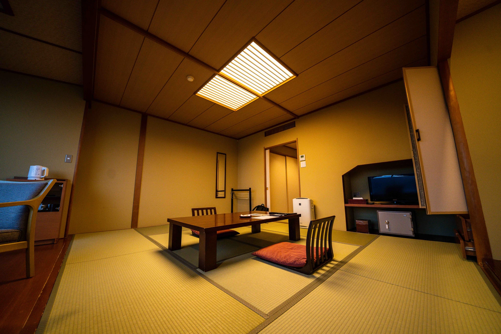 Wide view of a tatami guest room and low table