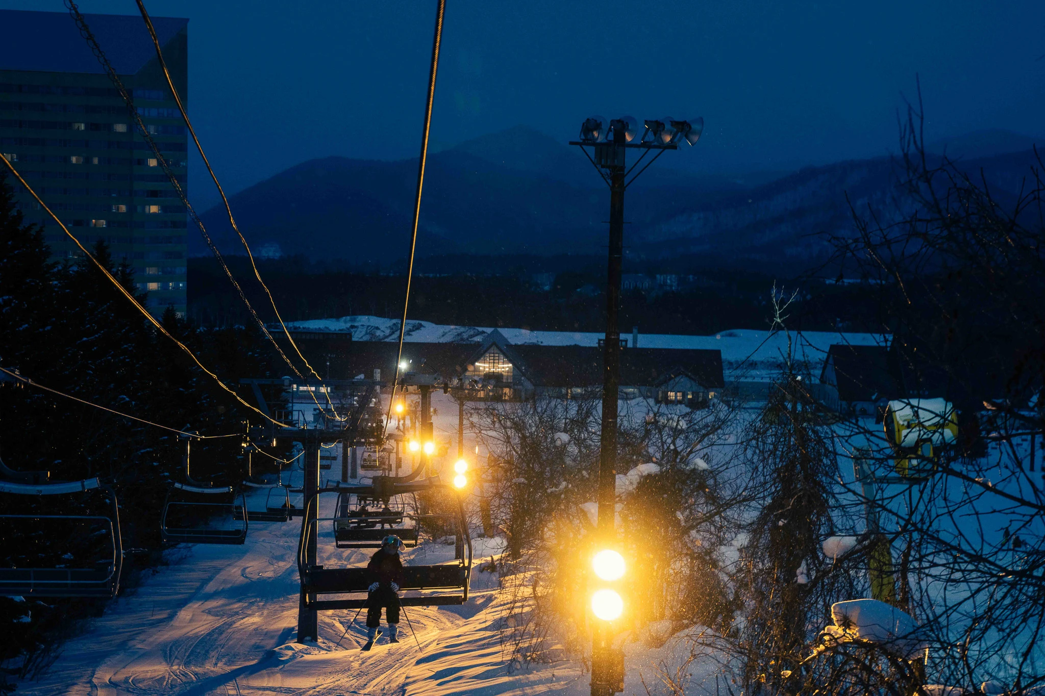 Ski lift illuminated in blue evening light
