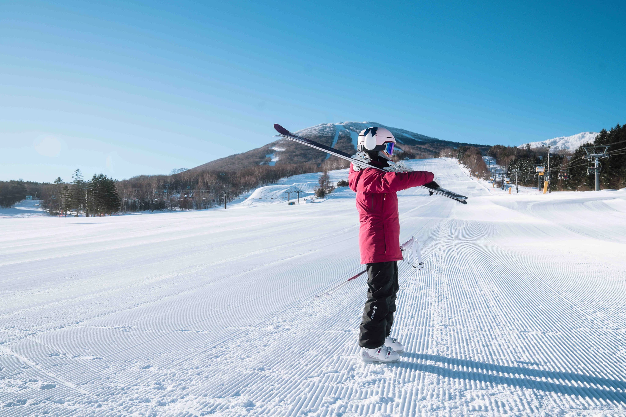 Visitor standing on a wide snowy slope
