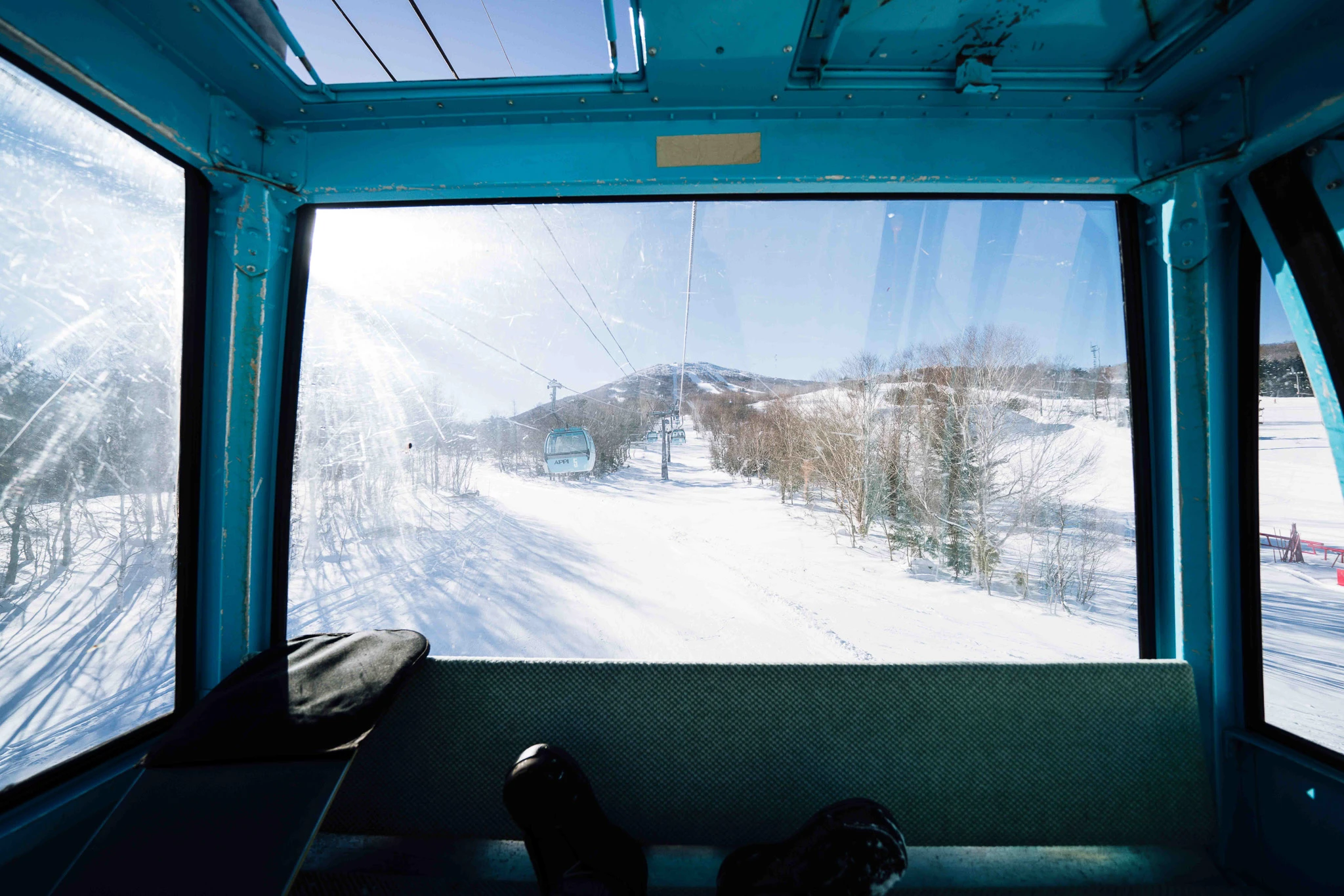 Snowy mountain seen through a cable-car window