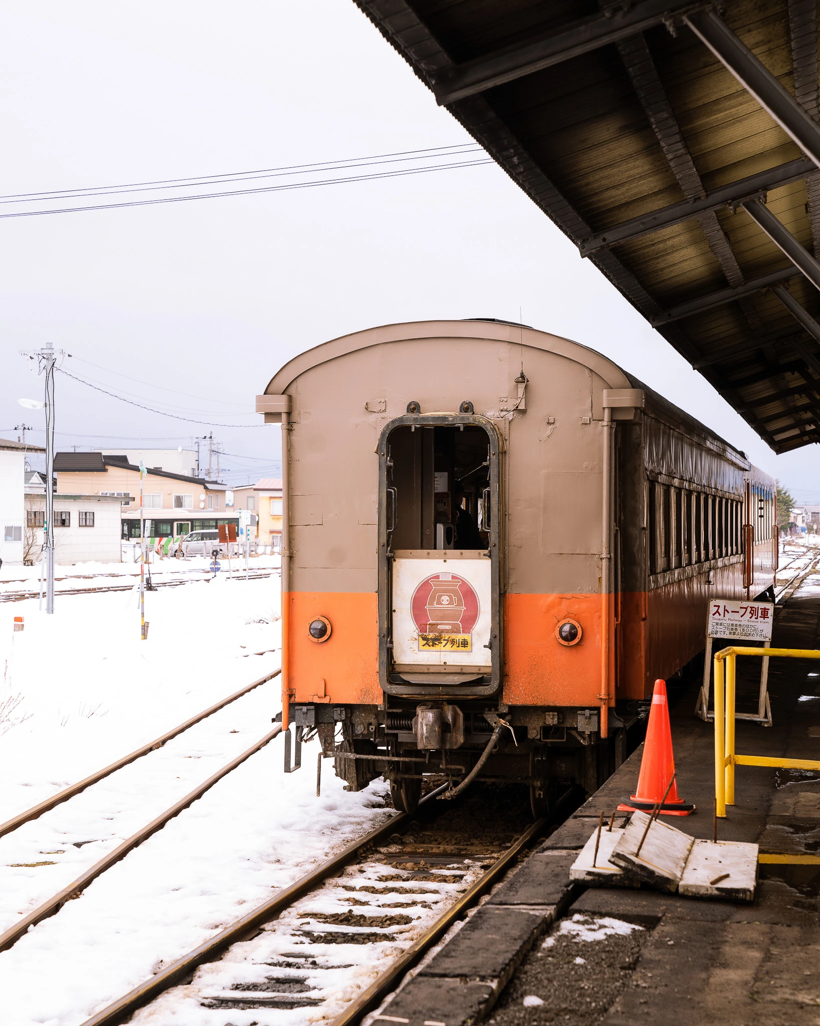 Rear of the train beside a snow-covered platform