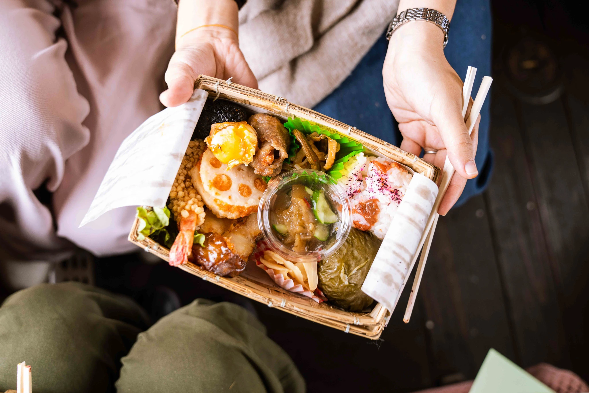 Passenger holding an open boxed lunch