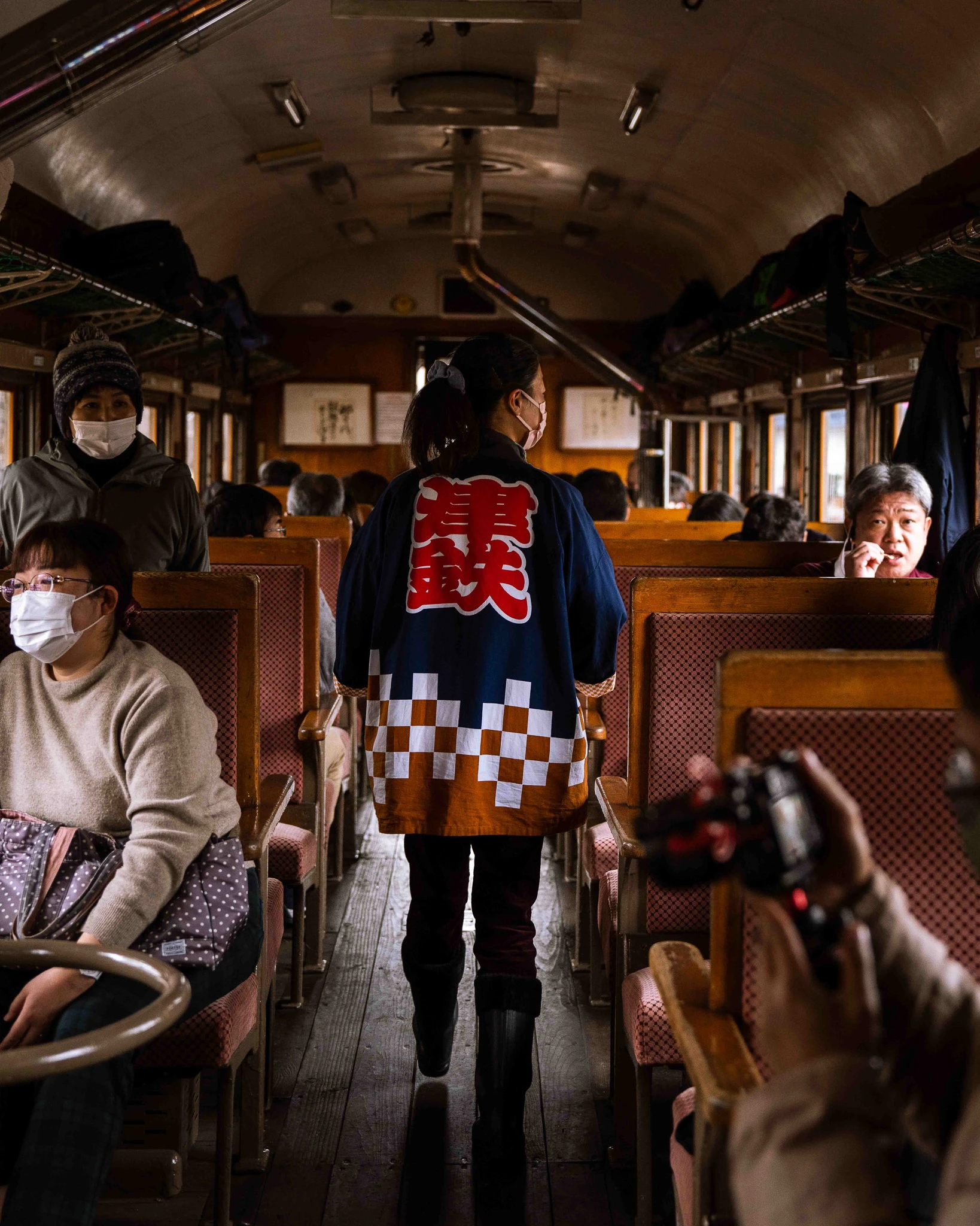 Onboard staff moving through the train carriage