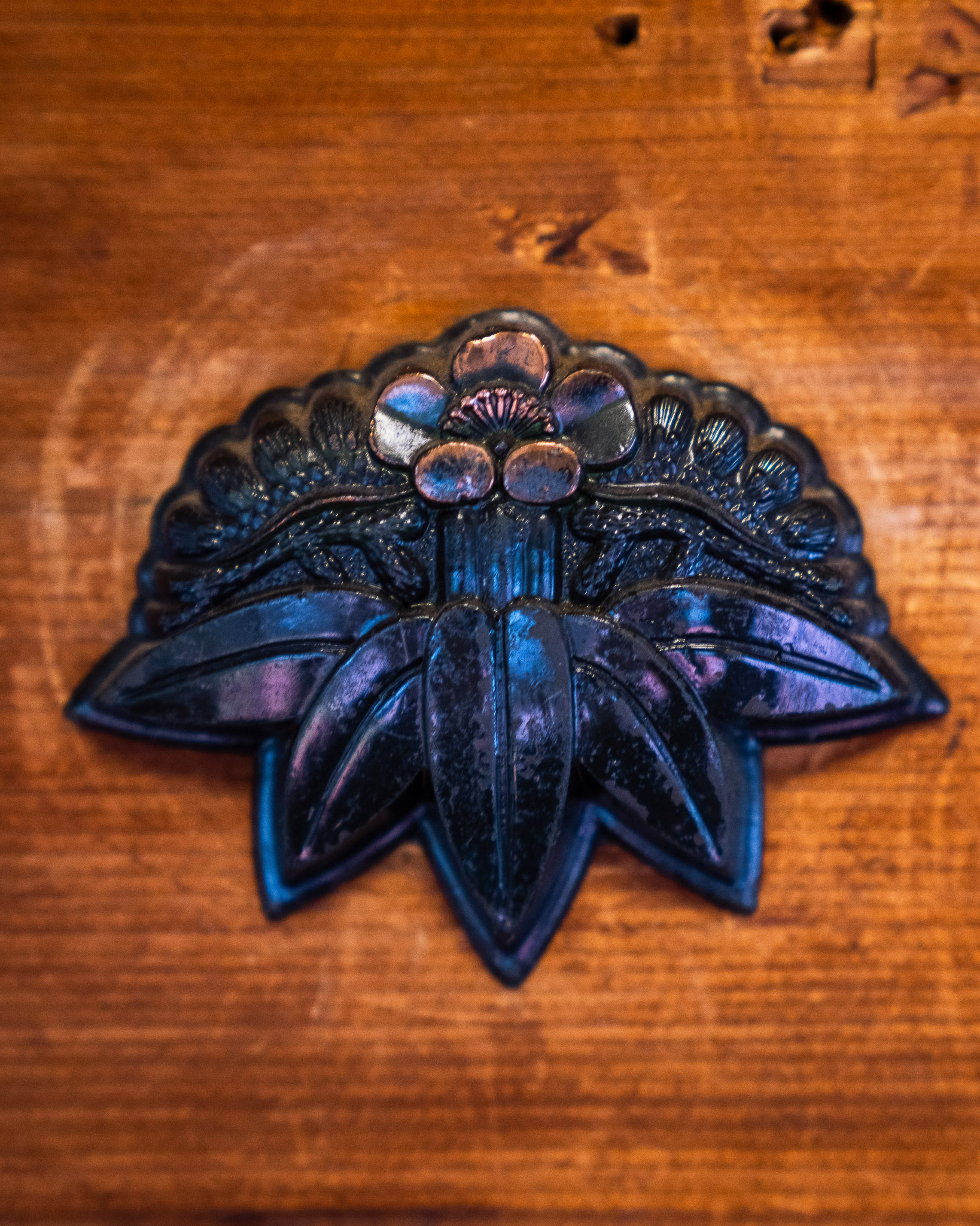 Decorative metal fitting on a timber surface