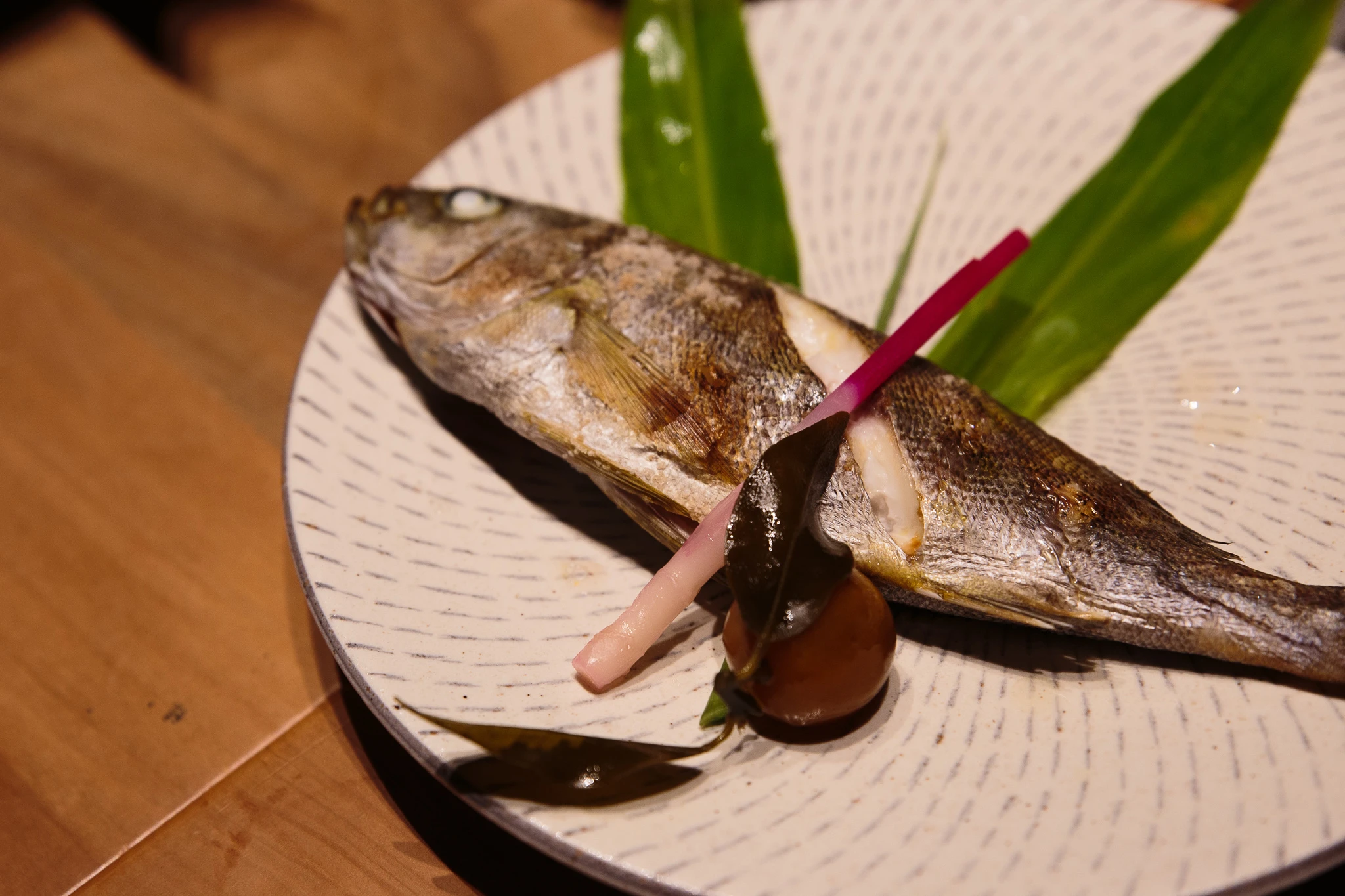 Grilled fish served on a patterned plate