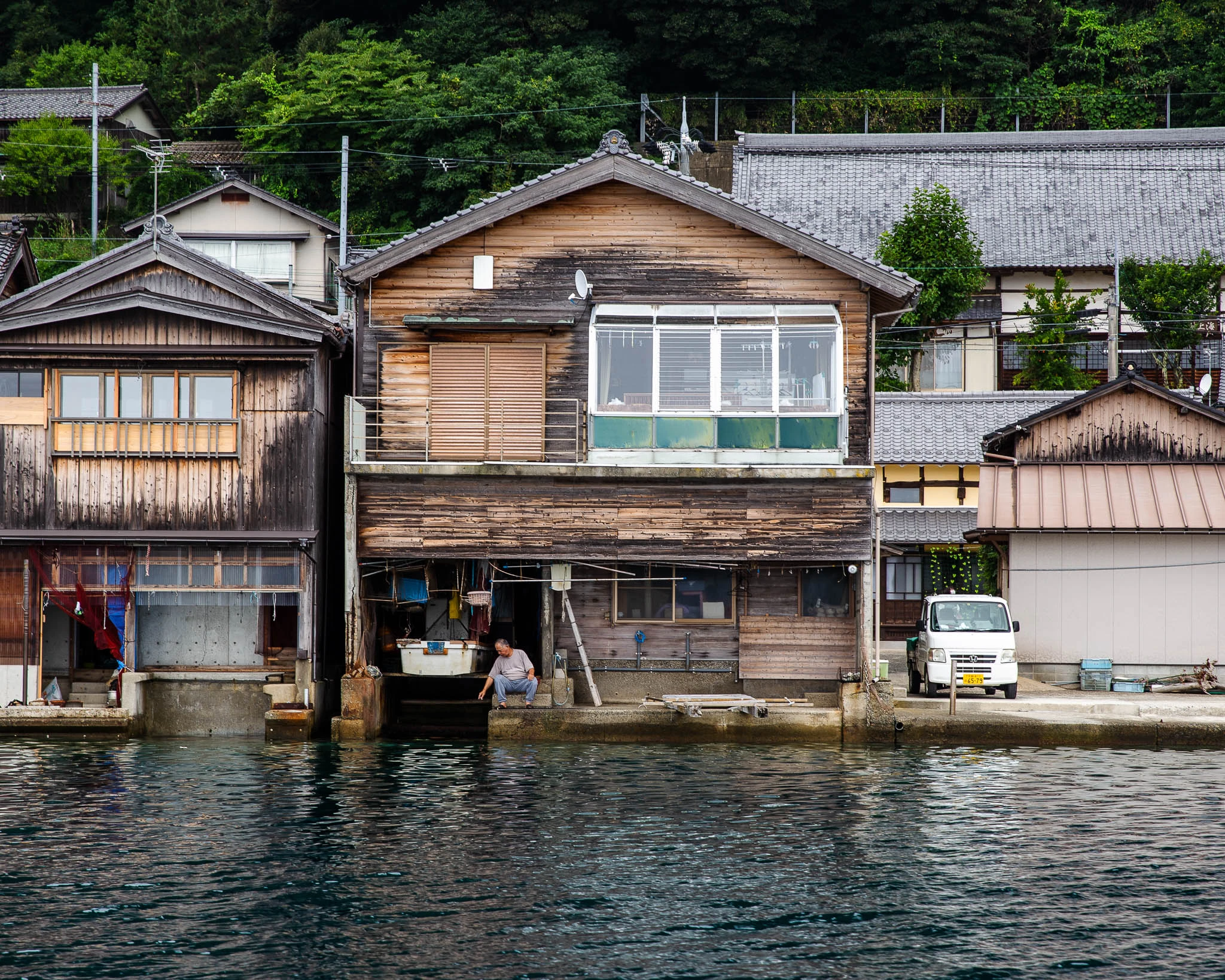 Weathered timber houses reflected in the water