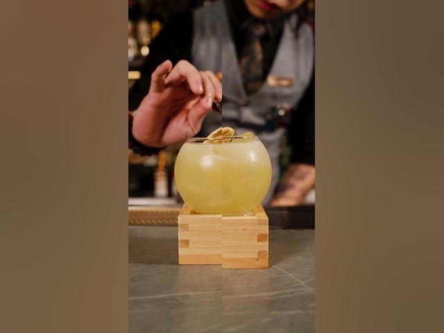 A Moonwell bartender garnishing a yellow cocktail