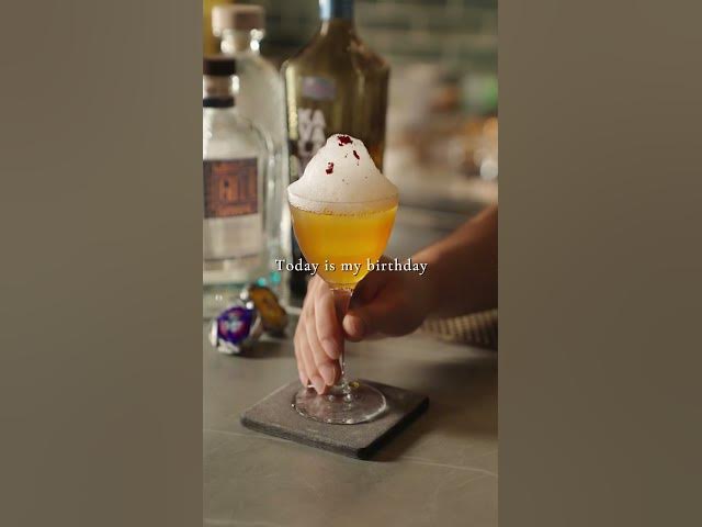A foam-topped yellow cocktail served at the Moonwell bar